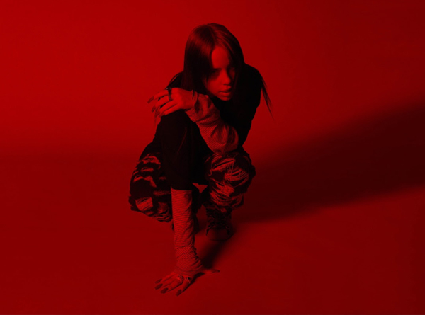 Billie Eilish photographed in red light.