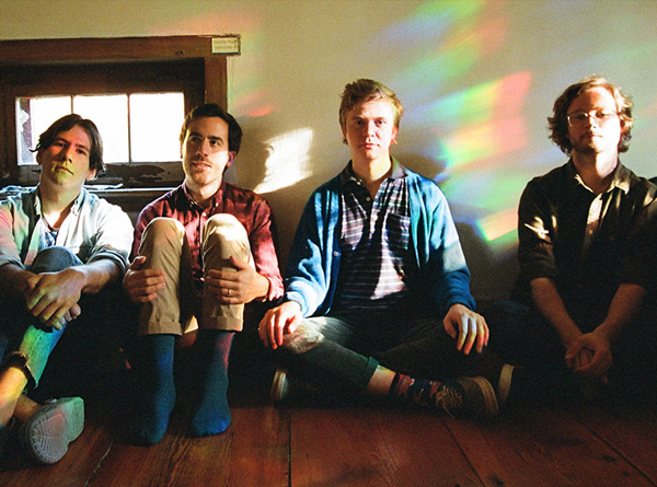 Pinegrove band photo. 4 members sitting on the floor