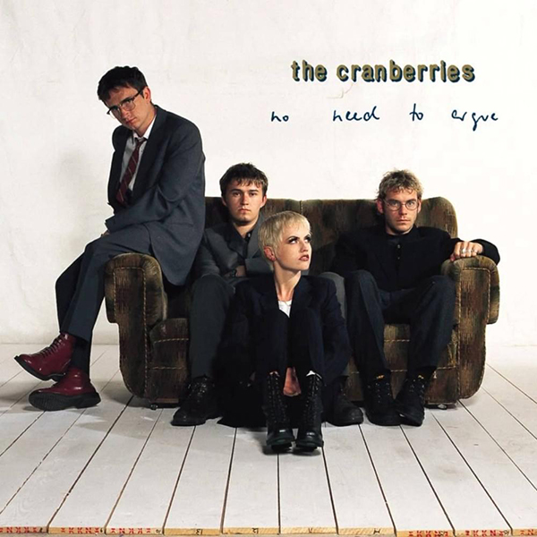 The Cranberries - No Need To Argue album artwork. Band sitting on couch in white room.