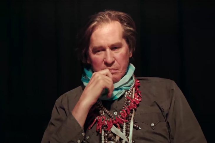 photo of modern-day Val Kilmer sitting with a contemplative look on his face.