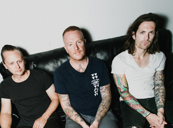 Eve 6 band members sitting on couch