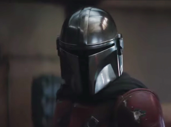screen capture of The Mandalorian - Star wars character wearing face-covering helmet