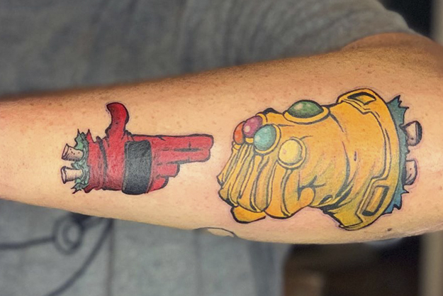 tattoo of Deadpool's hand and Thanos' Infinity Gauntlet recreating the Run the Jewels logo