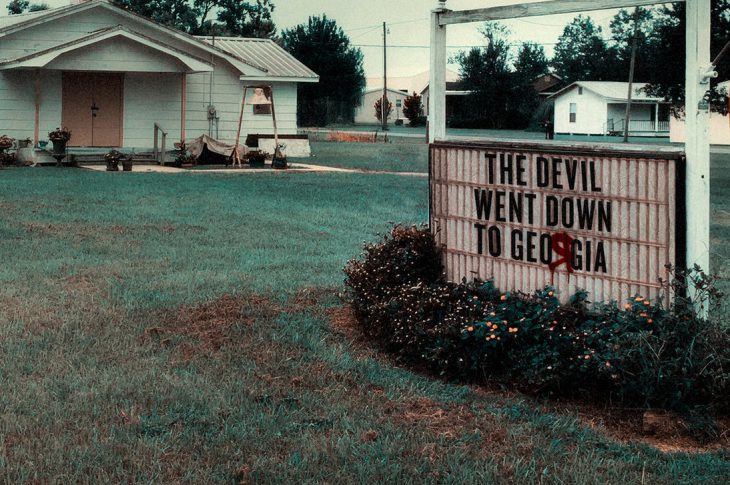 Devil Went Down To Georgia artwork. Signboard in front of church with song title.