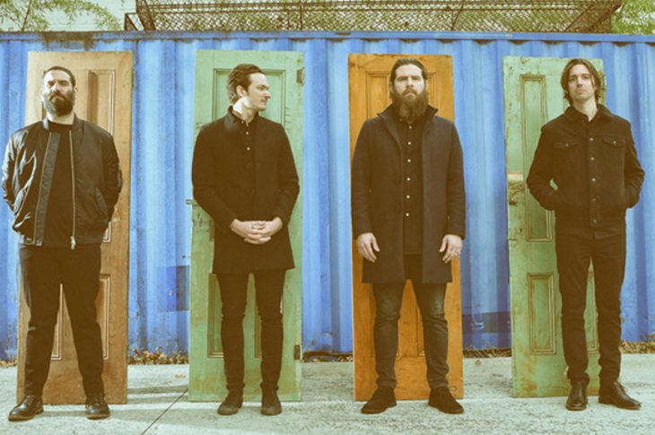 press photo of Manchester Orchestra members each standing in front of a colorful door.