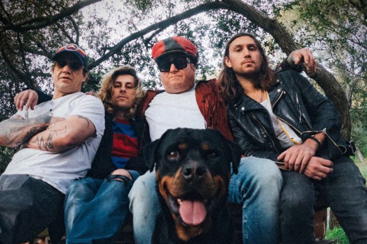 band photo of members of Spray Allen with dog.