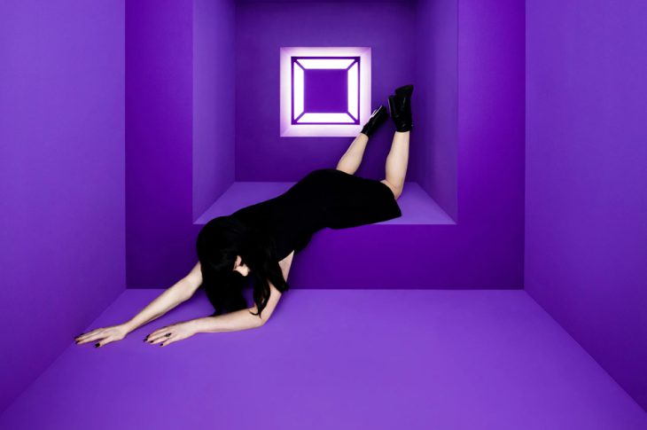 Olivia jean laying facedown on purple backdrop (album cover for Raving Ghost)