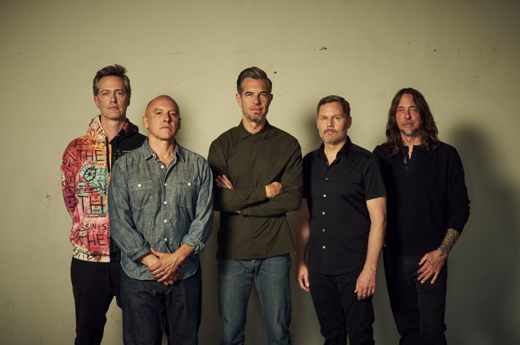 5 band members of 311 posed against wall
