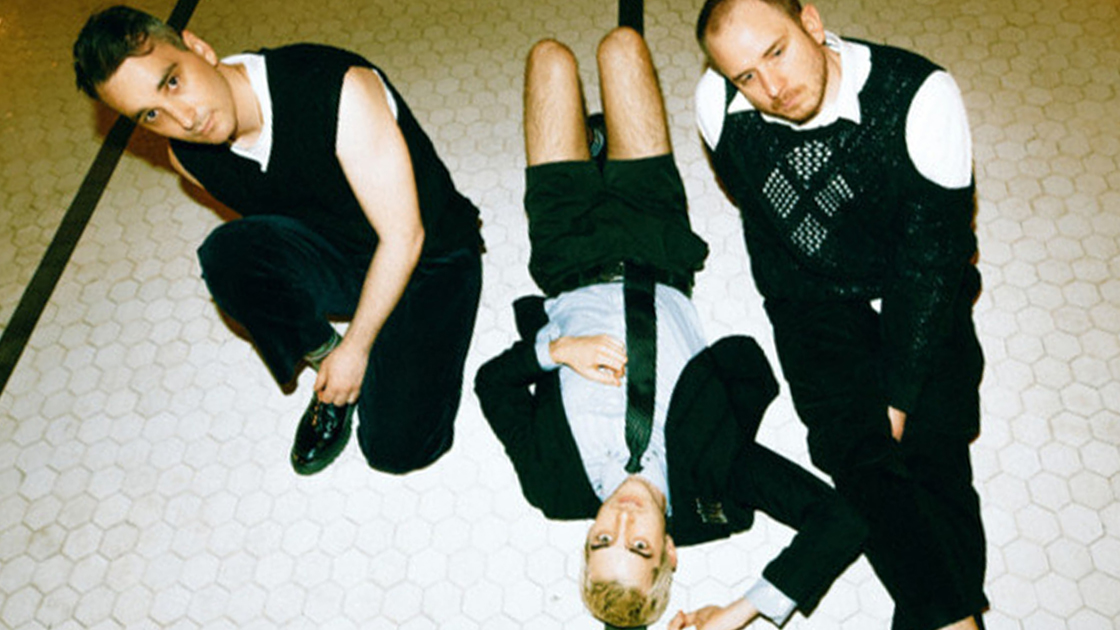 three people sitting on the floor, looking up at camera