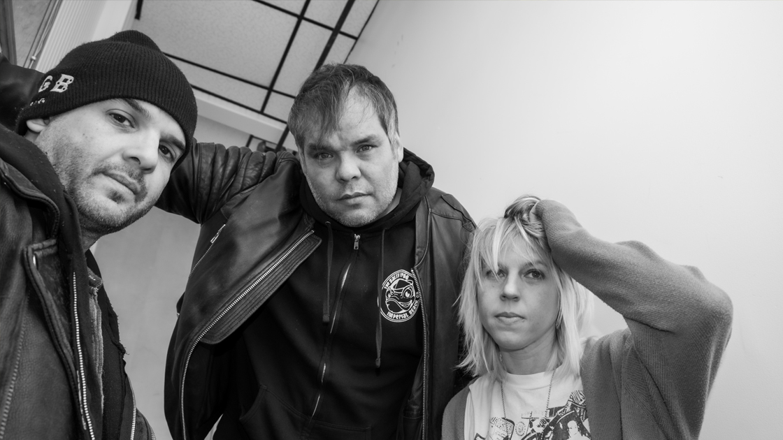 Three people photographed in stairwell