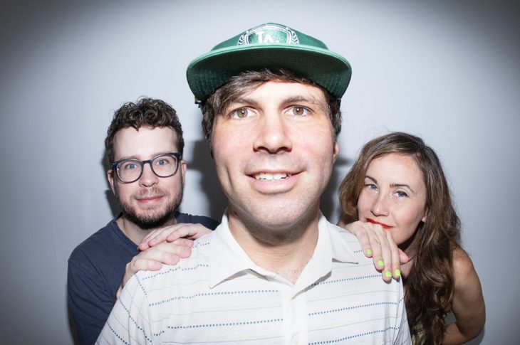 close up photo of 2 men and 1 woman looking at the camera