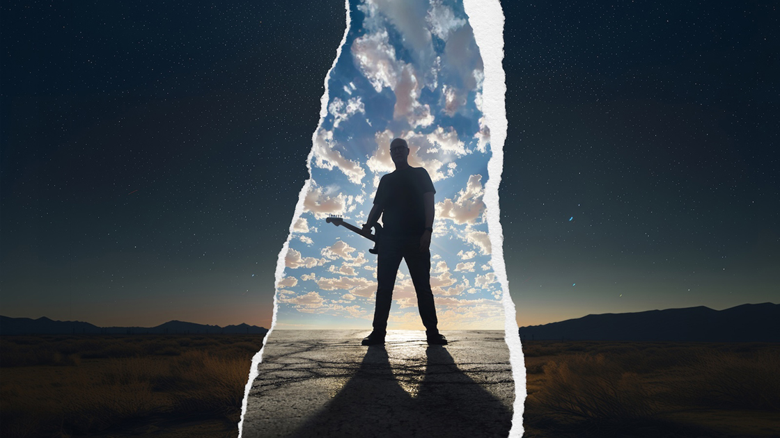 Man standing with guitar against cloud filled sky