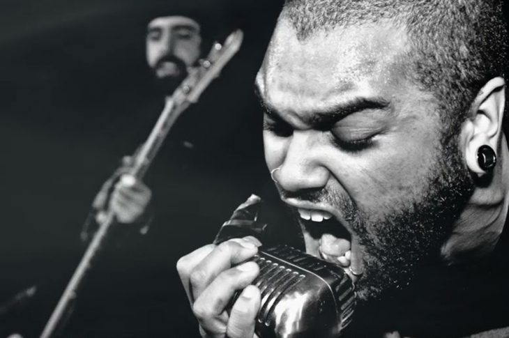 black and white photo of singer screaming into a microphone.