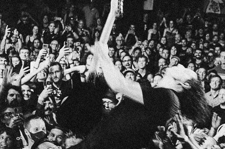 Man playing guitar in front of audience