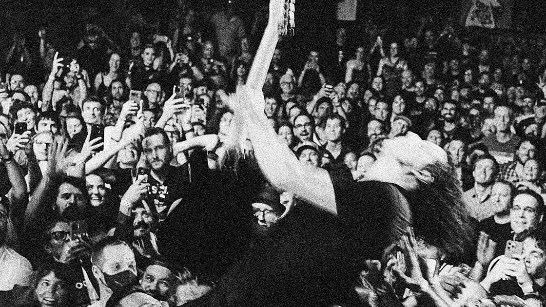 Man playing guitar in front of audience