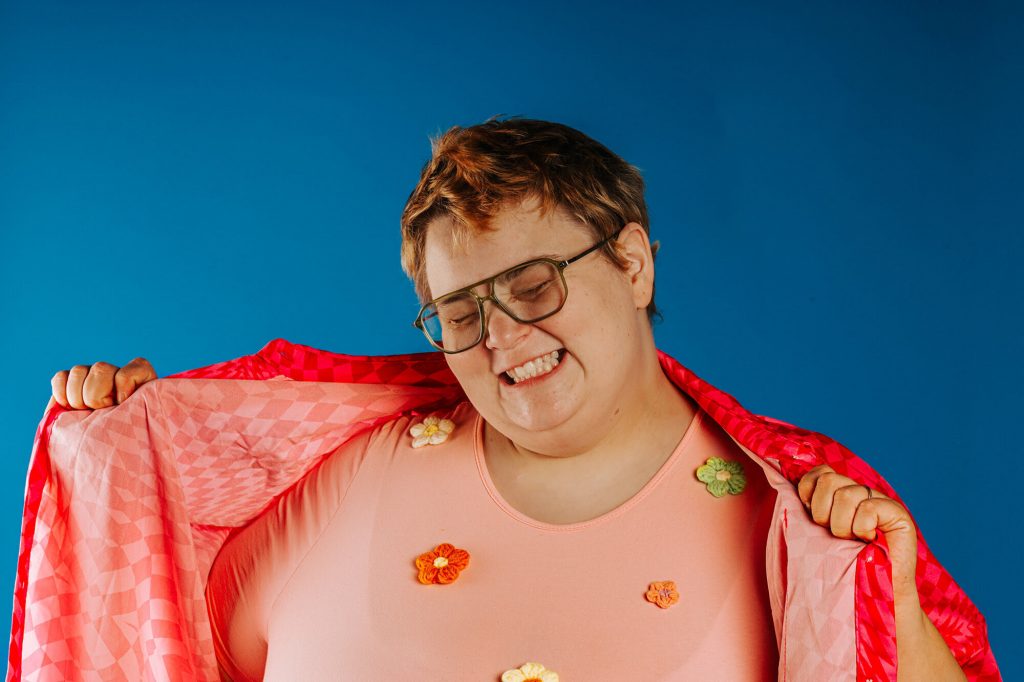 Artist photographed against blue background