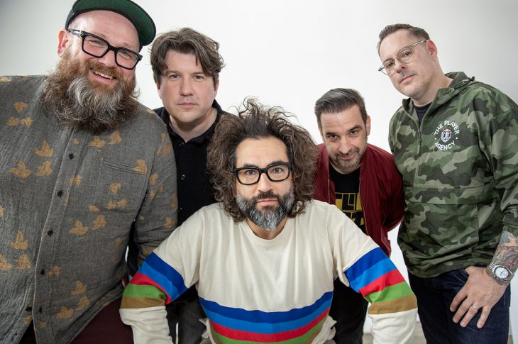 Photo of 5 men photographed against white background