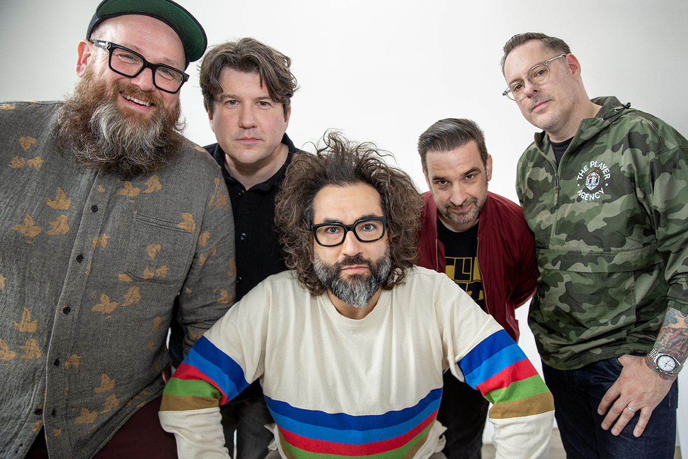 Photo of 5 men photographed against white background