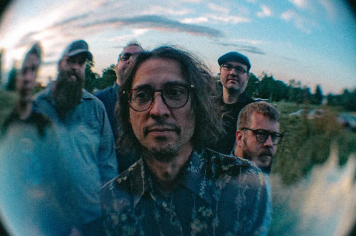 photo of 6 musicians taken in a field with fish eye lens.