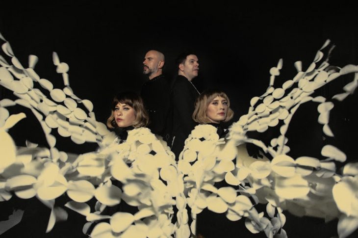 4 people with white flowery strands photographed against white background