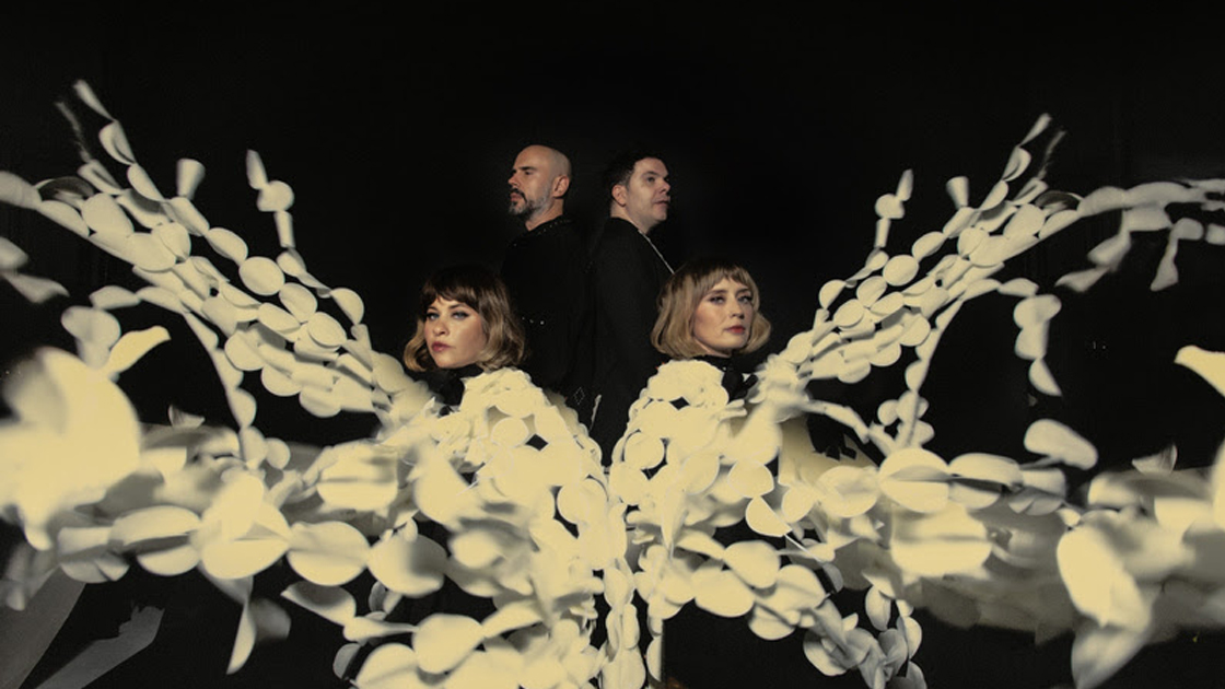 4 people with white flowery strands photographed against white background