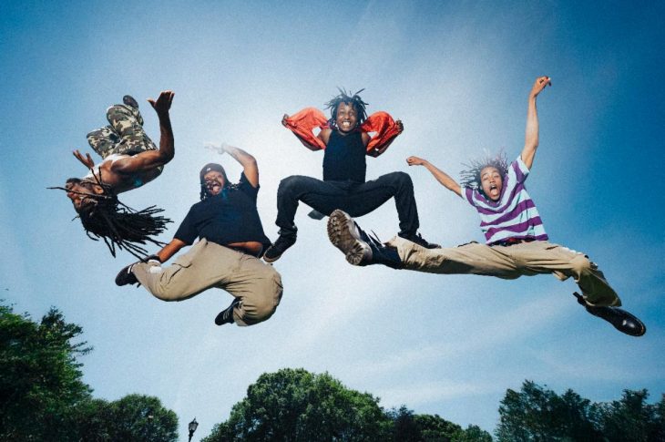 four young men jumping in the air