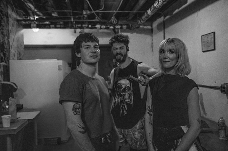 black and white photo of three musicians in a room