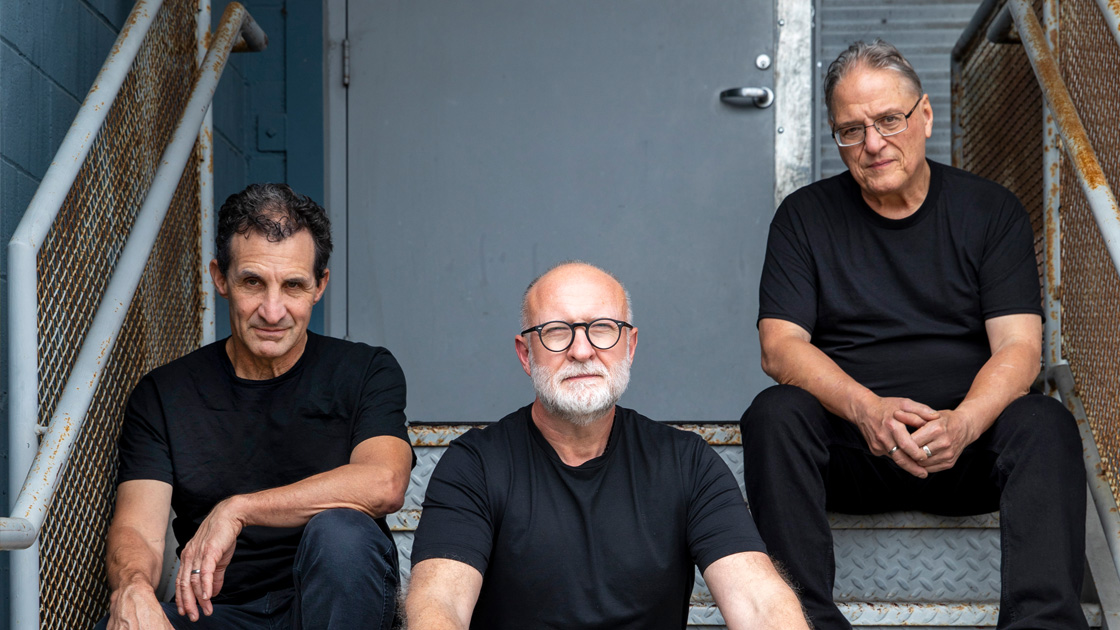three men sitting on stairs