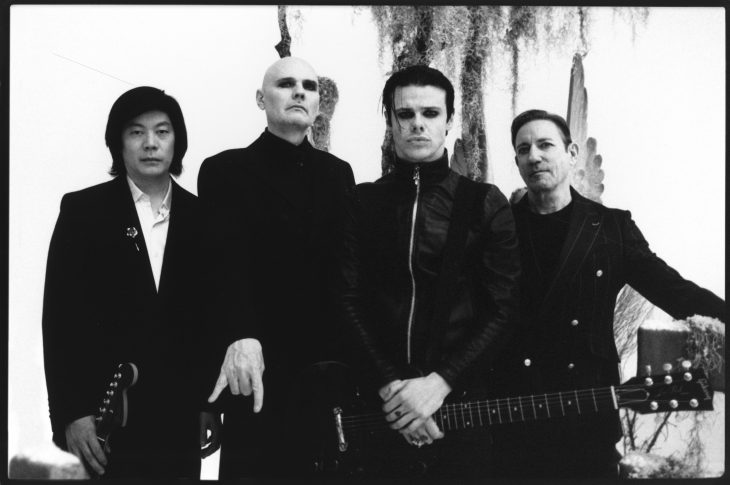 black and white photo of 4 men standing outside