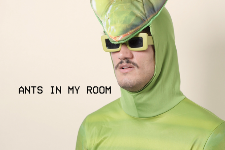 man wearing insect costume and sunglasses photographed against white background.