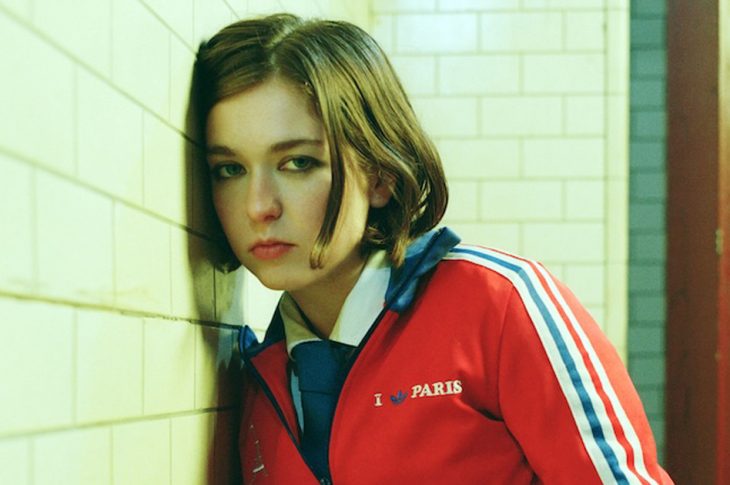 Woman leaning against wall