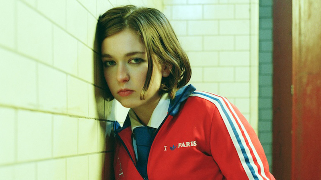 Woman leaning against wall