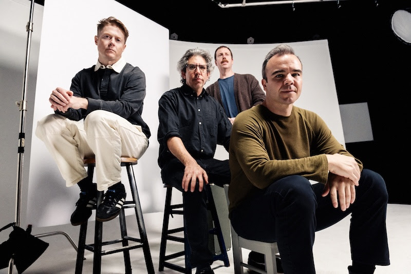 Four men photographed in studio