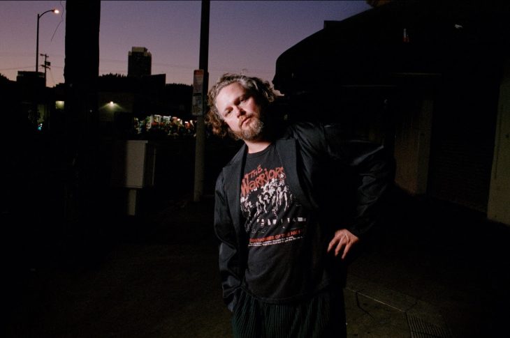photo of man standing on street at night
