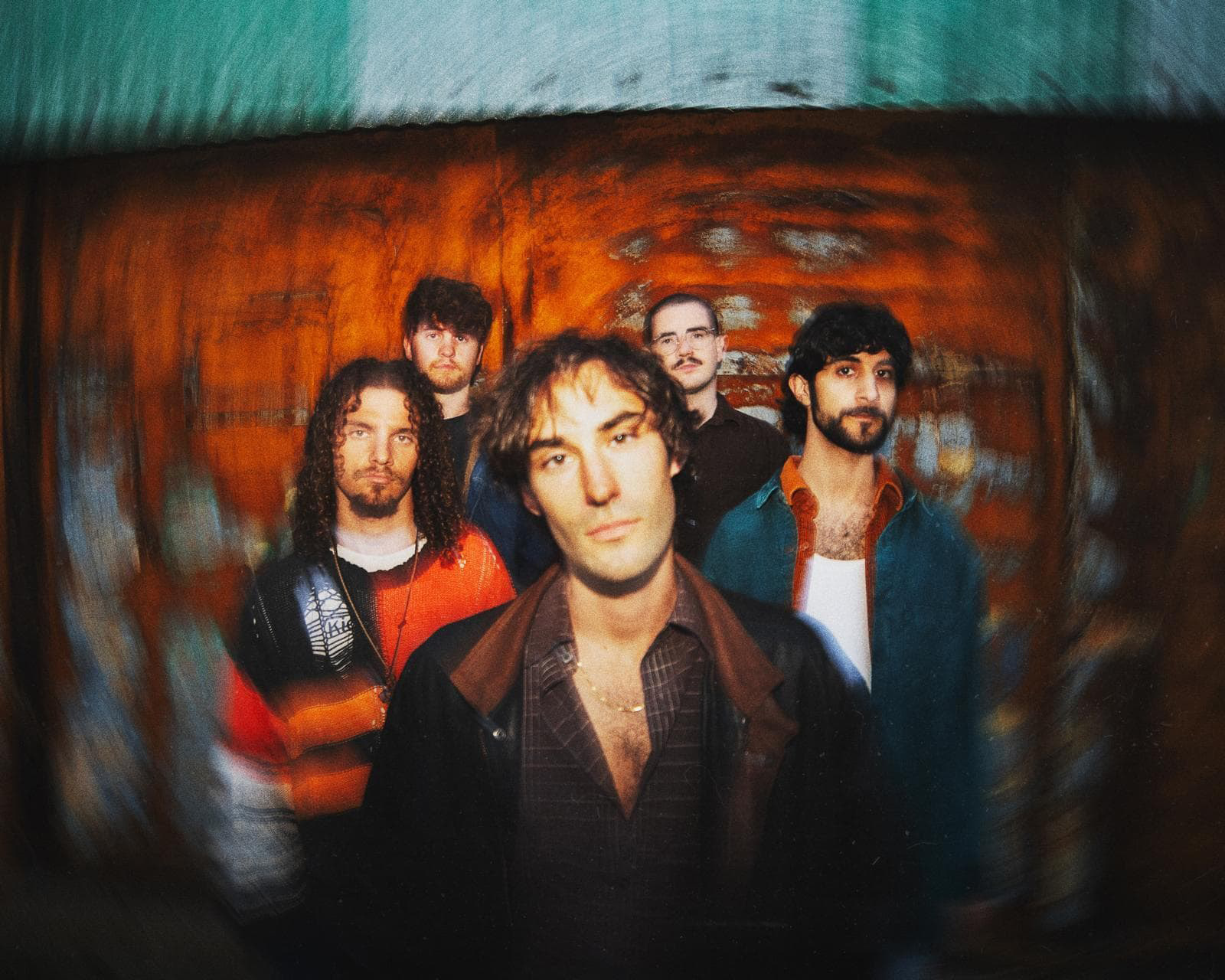 Five men photographed against colorful background