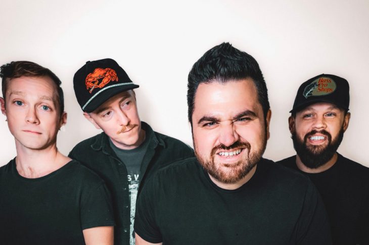 four men photographed against white backdrop