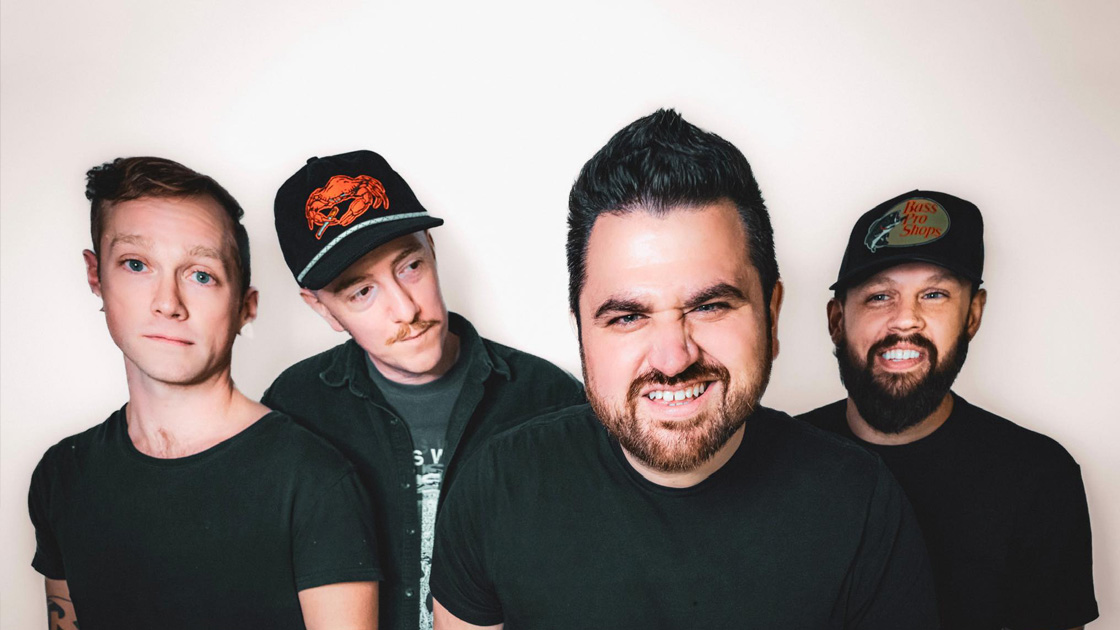 four men photographed against white backdrop