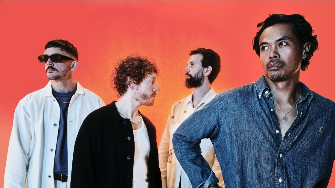 four men photographed against orange backdrop