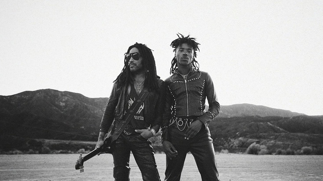 Black and white photo of two men standing in the desert.