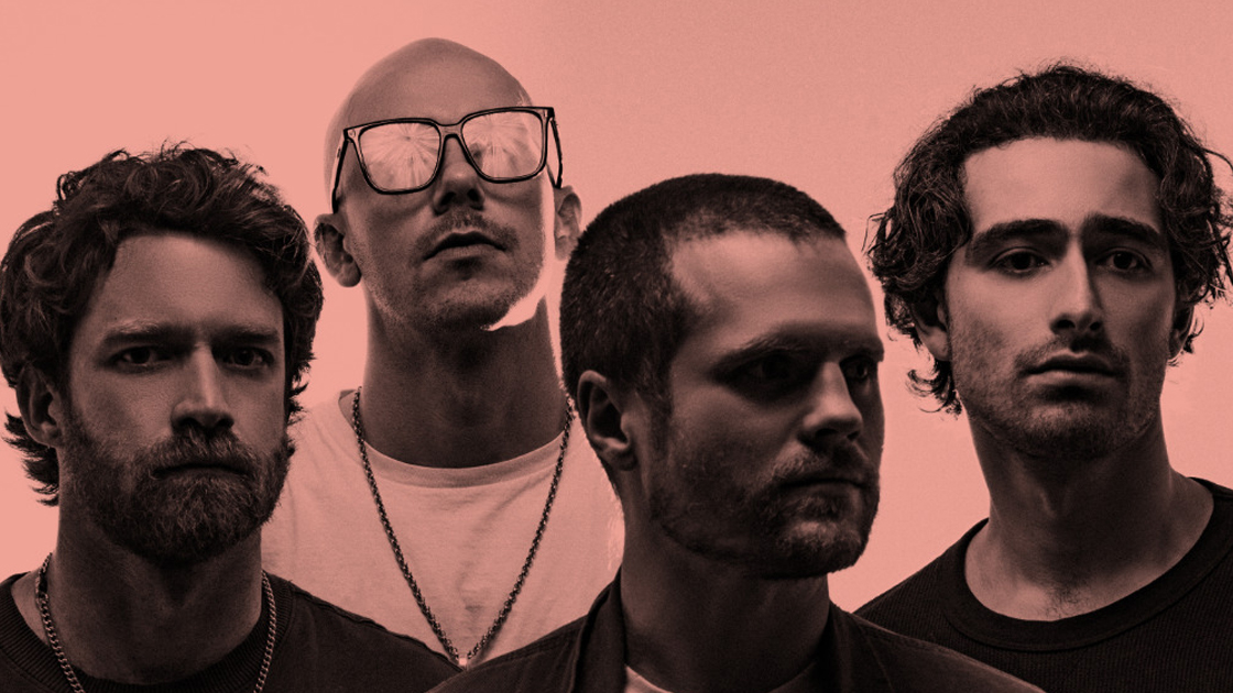 Pink-hued photo of four men