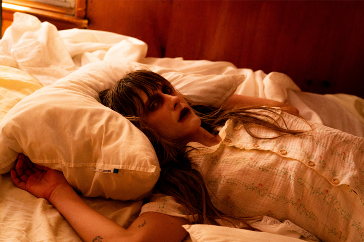 photo of possessed woman lying on bed.