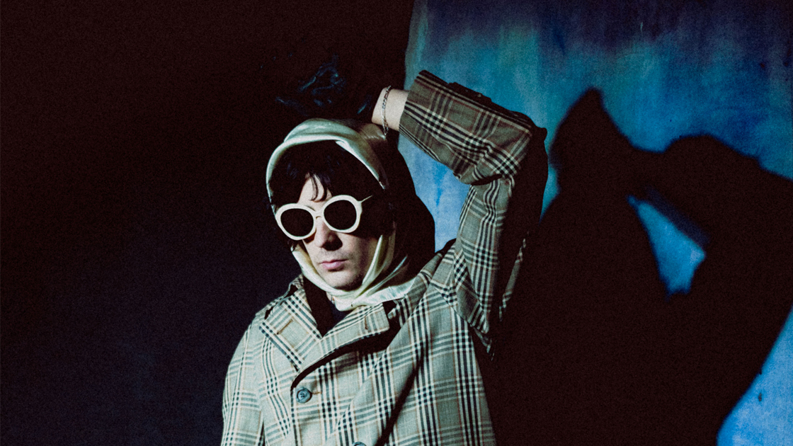 Photo of man in coat and sunglasses