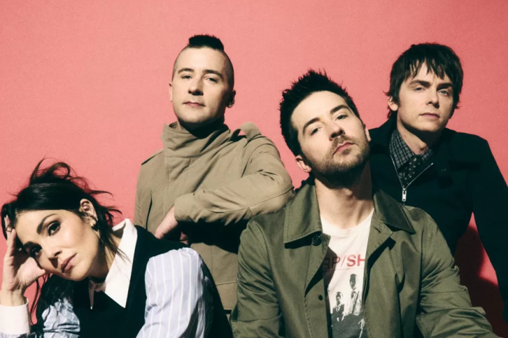 Four people photographed against red background