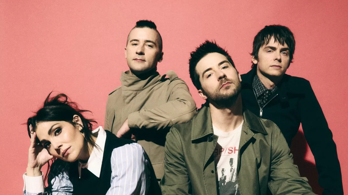 Four people photographed against red background