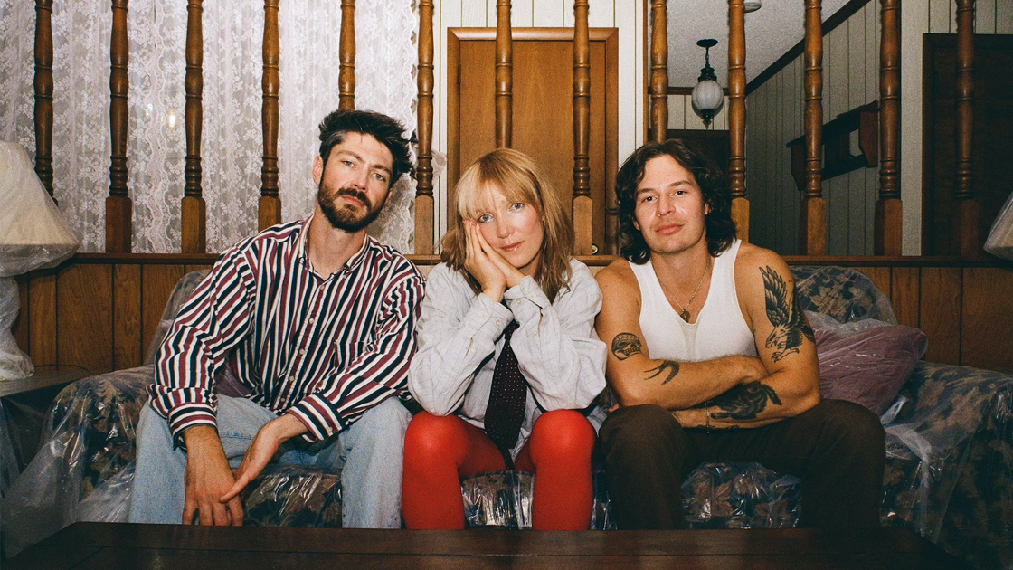 three people sitting on a couch